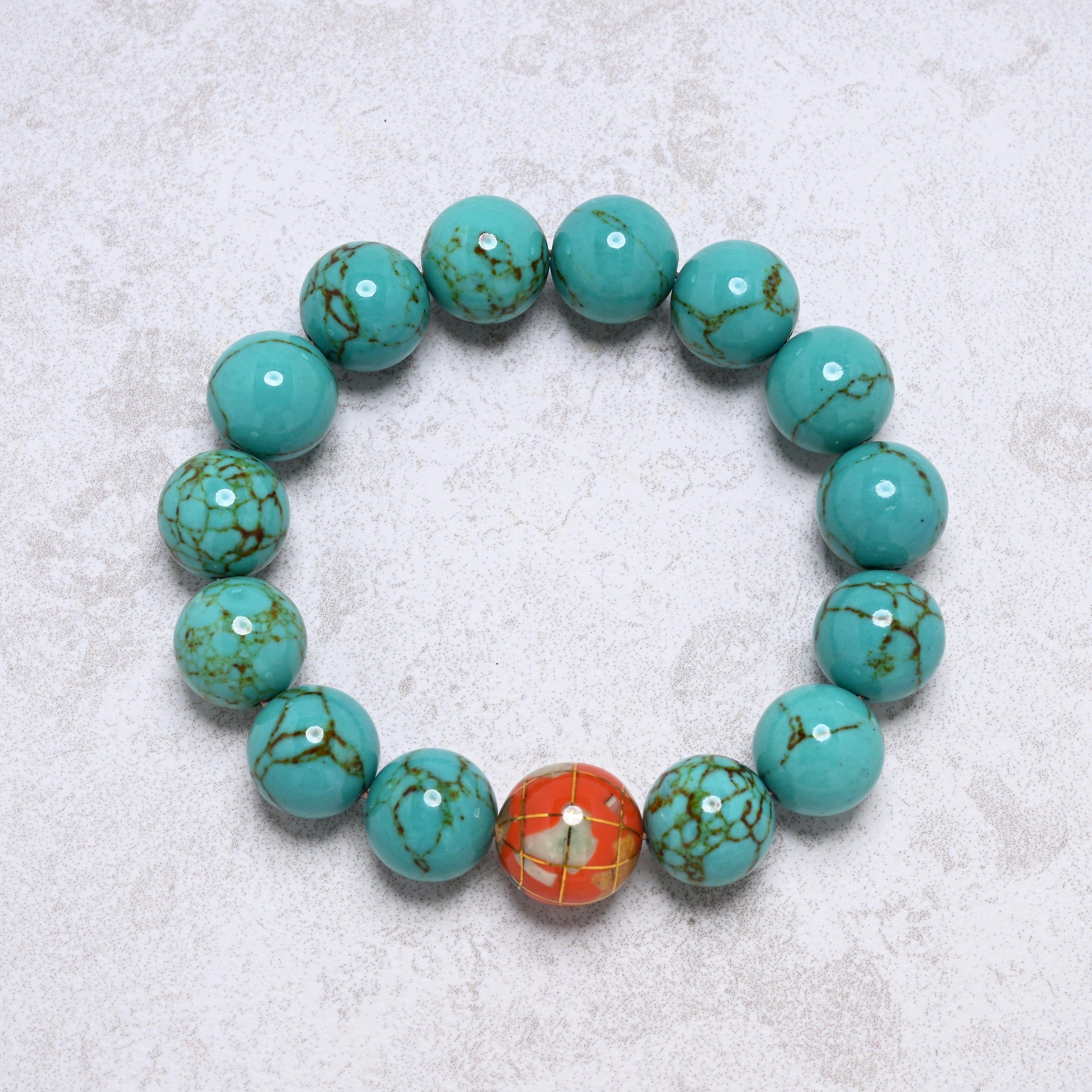 KALIFANO Gemstone Jewelry 14mm Howlite Turquoise Gemstone Elastic Bracelet with Orange Globe Accent Bead