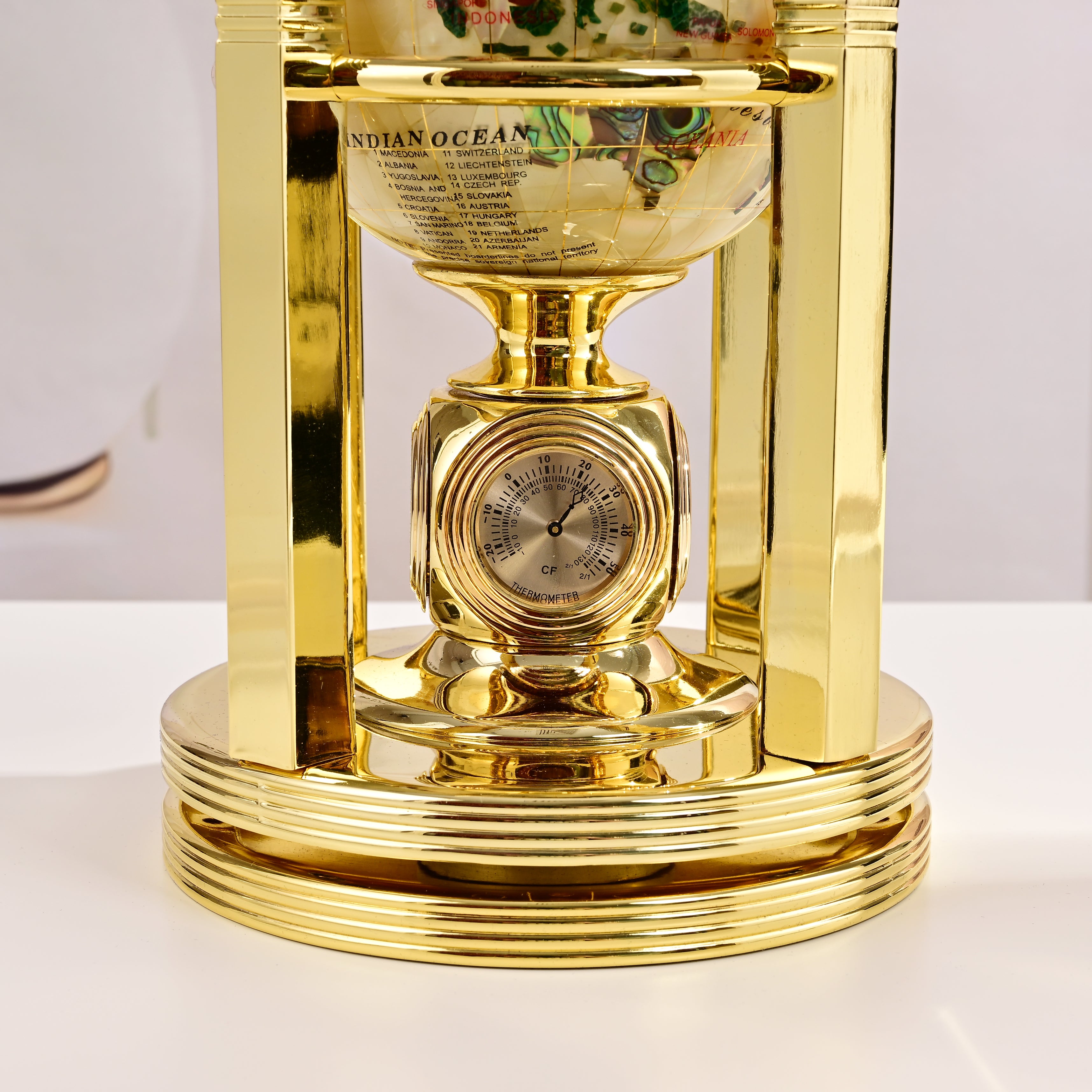 8.5" Tall Gemstone Globe with 5" Mother of Pearl Diamond Cut Ocean on 24k Gold Plated Bi-directional rotating Stand