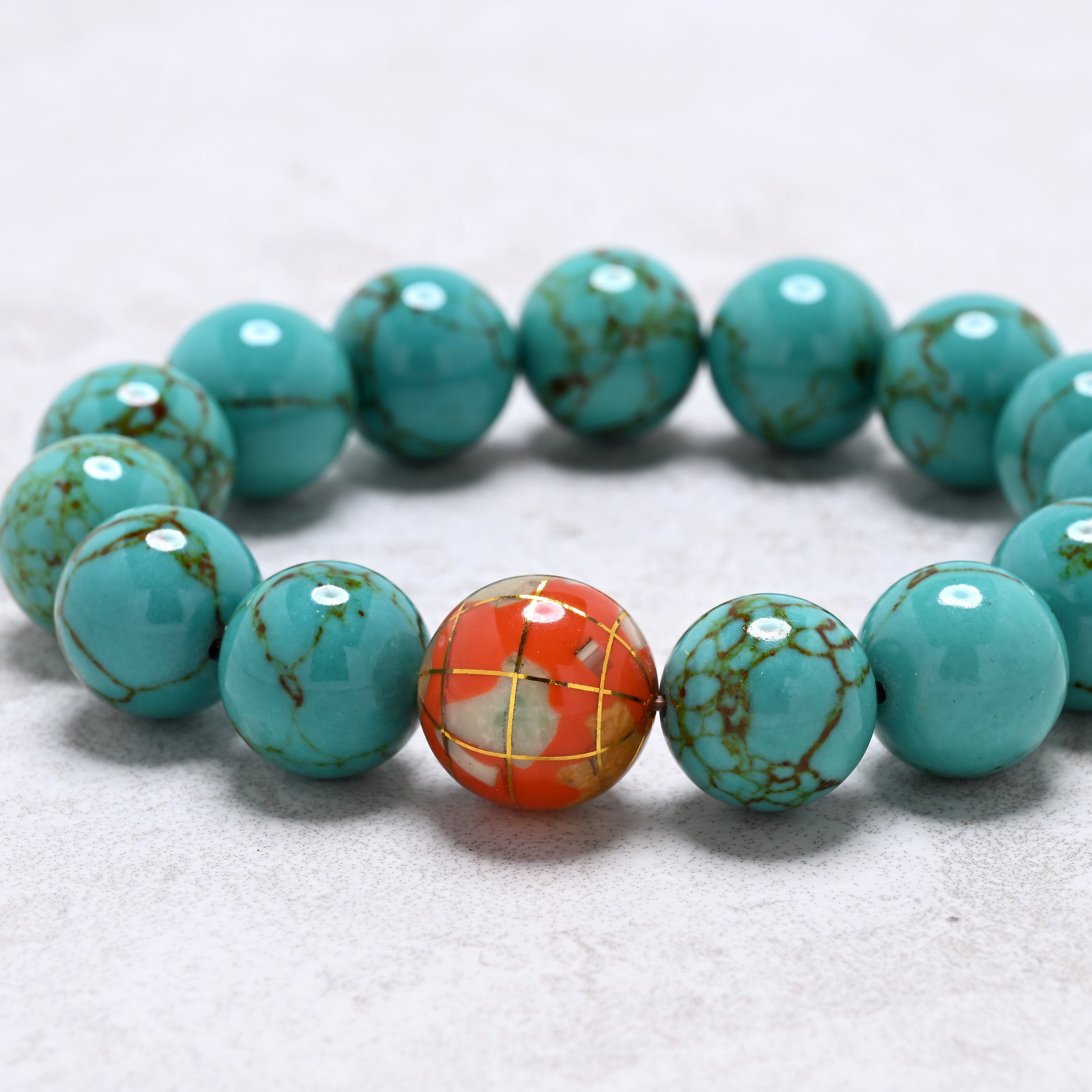 KALIFANO Gemstone Jewelry 14mm Howlite Turquoise Gemstone Elastic Bracelet with Orange Globe Accent Bead