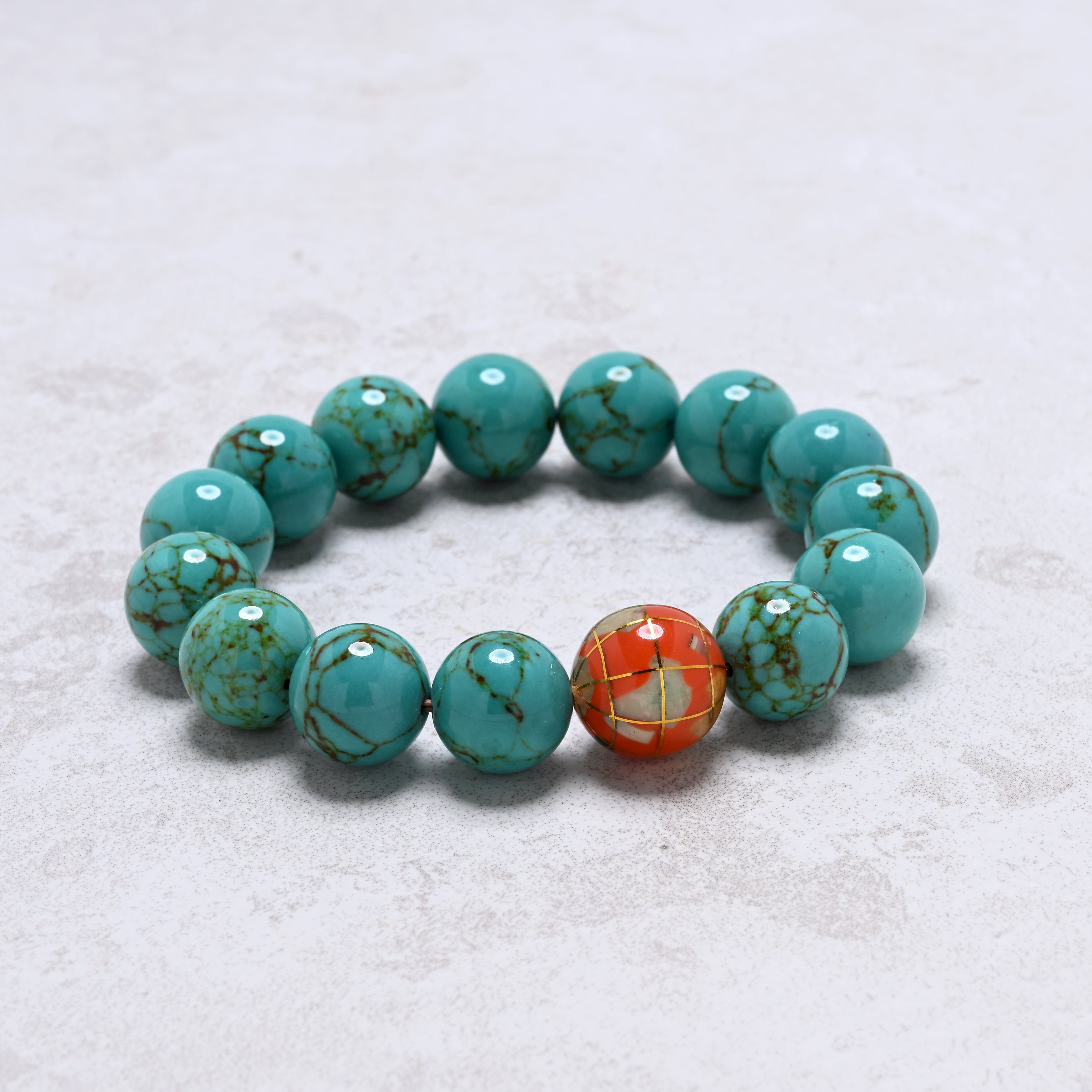 KALIFANO Gemstone Jewelry 14mm Howlite Turquoise Gemstone Elastic Bracelet with Orange Globe Accent Bead