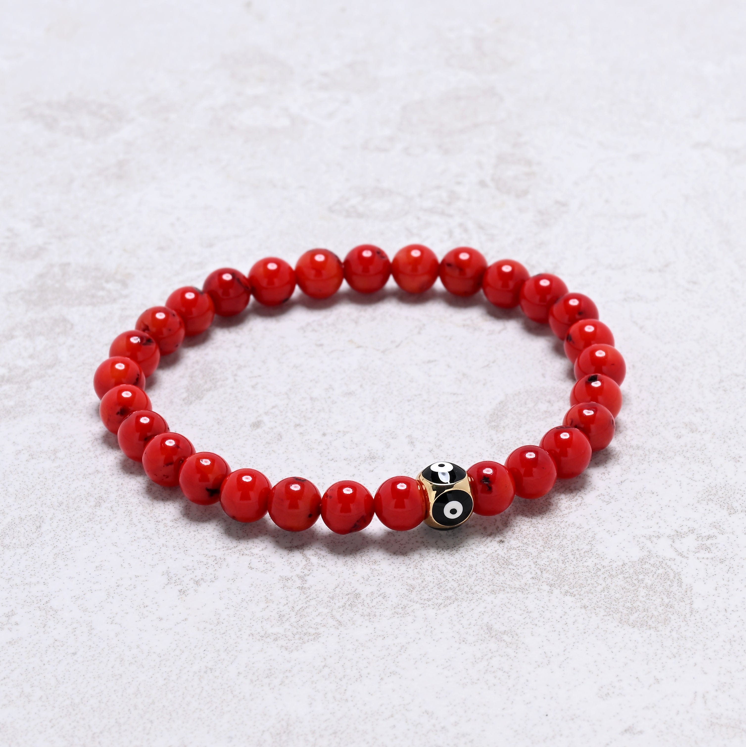 KALIFANO Gemstone Jewelry 6.3" Elastic 6mm Genuine Coral Beaded Bracelet with Vintage Evil Eye 8mm Black Bead NB-004-BKRC-S