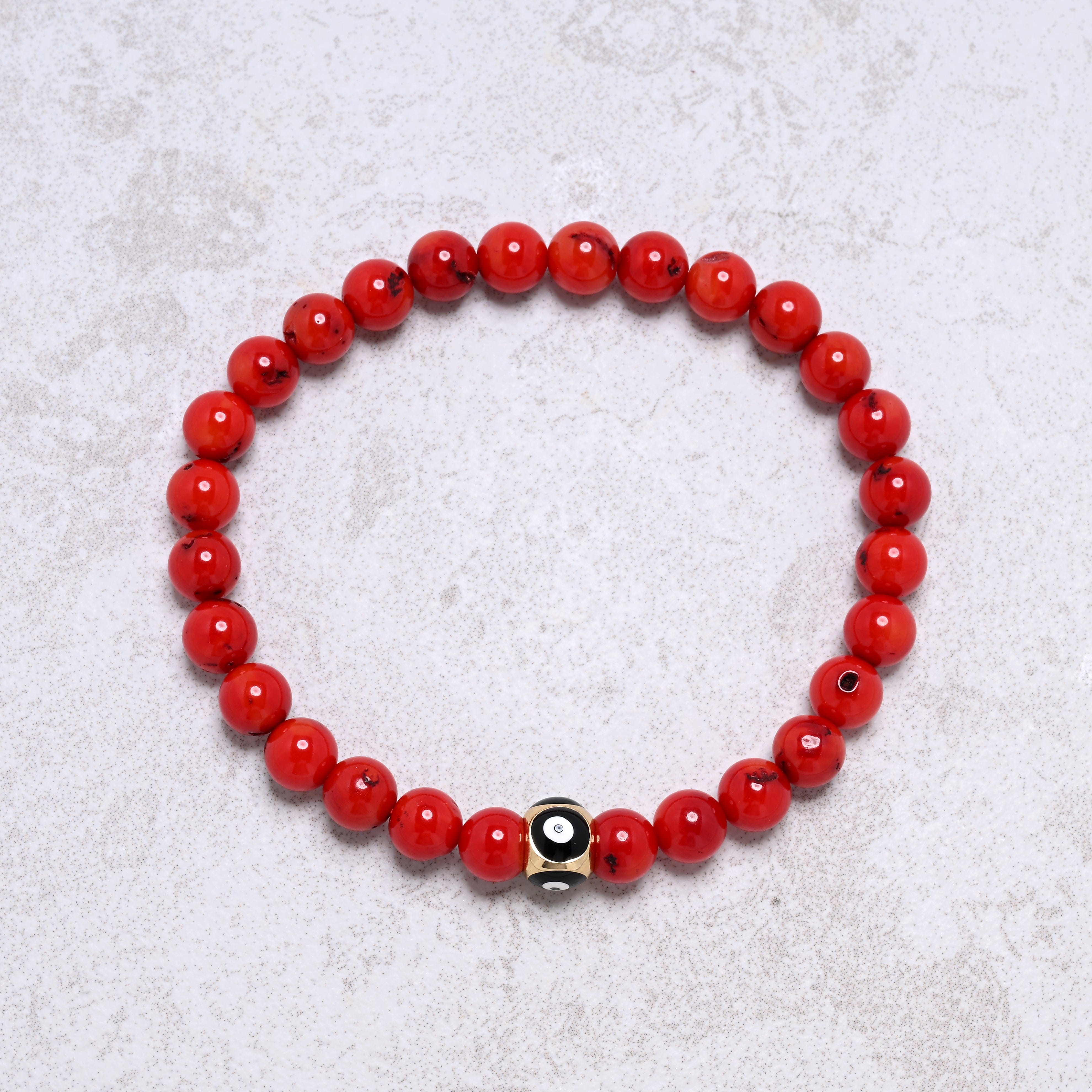 KALIFANO Gemstone Jewelry 6.3" Elastic 6mm Genuine Coral Beaded Bracelet with Vintage Evil Eye 8mm Black Bead NB-004-BKRC-S